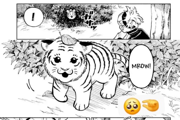 Baby tiger cub peeks out of the bushes