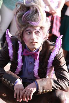 Eight foot joe from tokyo disney sea, wearing a similar outfit style (the purple accents are tentacles in his suit), his hair is also done up and silver-ish in color